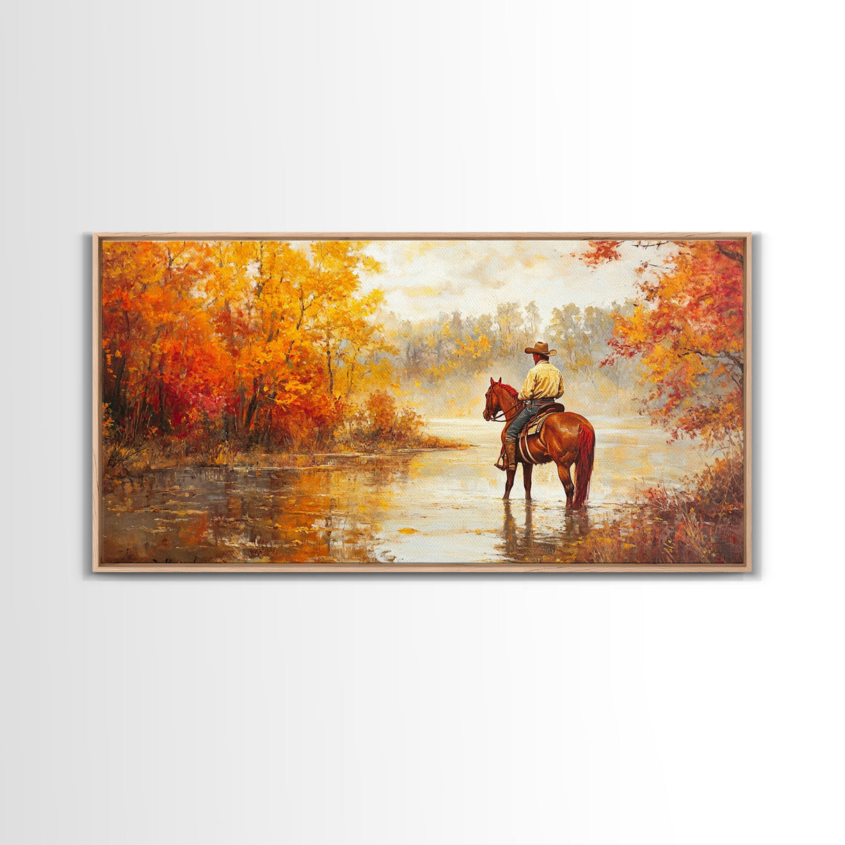 Cowboy sitting by campfire near a lake in the woods with autumn leaves, Framed Canvas Print, moody fall wall art, rustic western home decor