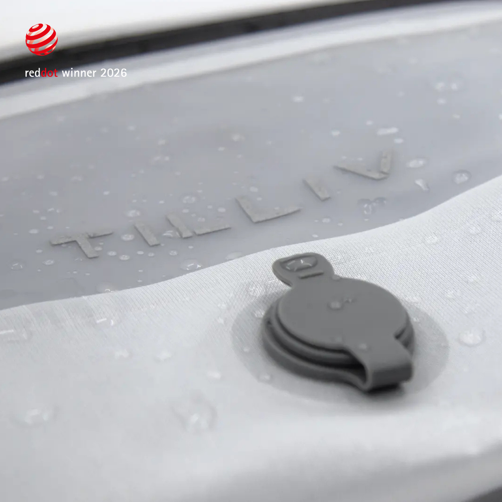 Water beading on the surface of a white TILLIV Compak pack beside its one-way valve, showing the water-resistant coating