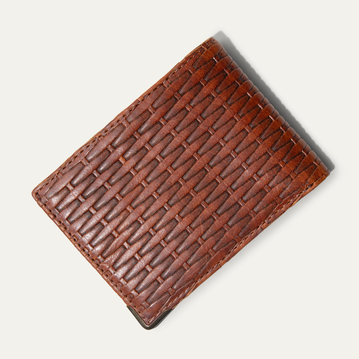 Overhead view of the cognac basketweave Mogul Billfold open flat, showing the card slots, embossed WILL logo, and mesh ID window.
