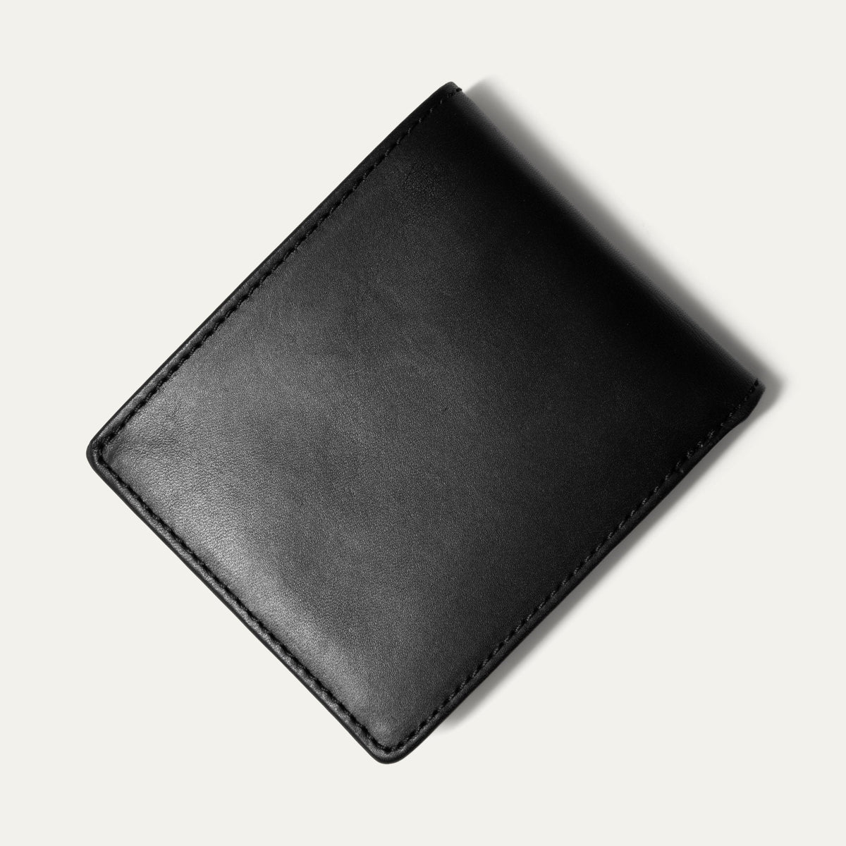 Black leather billfold wallet open, showing card slots, embossed WILL Leather Goods logo, and a clear ID window, on a white background.