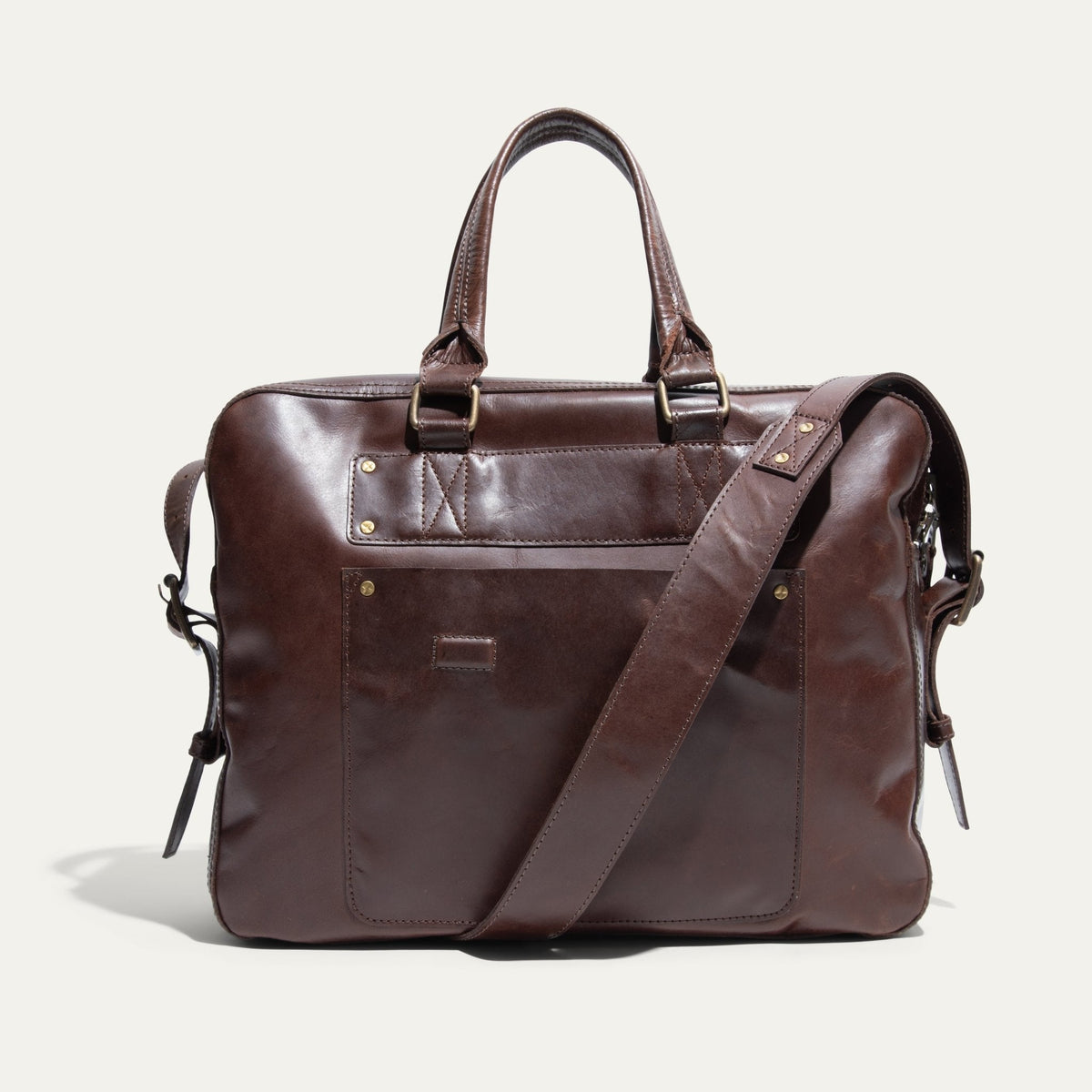 Dark brown leather briefcase, front pocket view, with zip top, snap-top front pocket, and adjustable shoulder strap