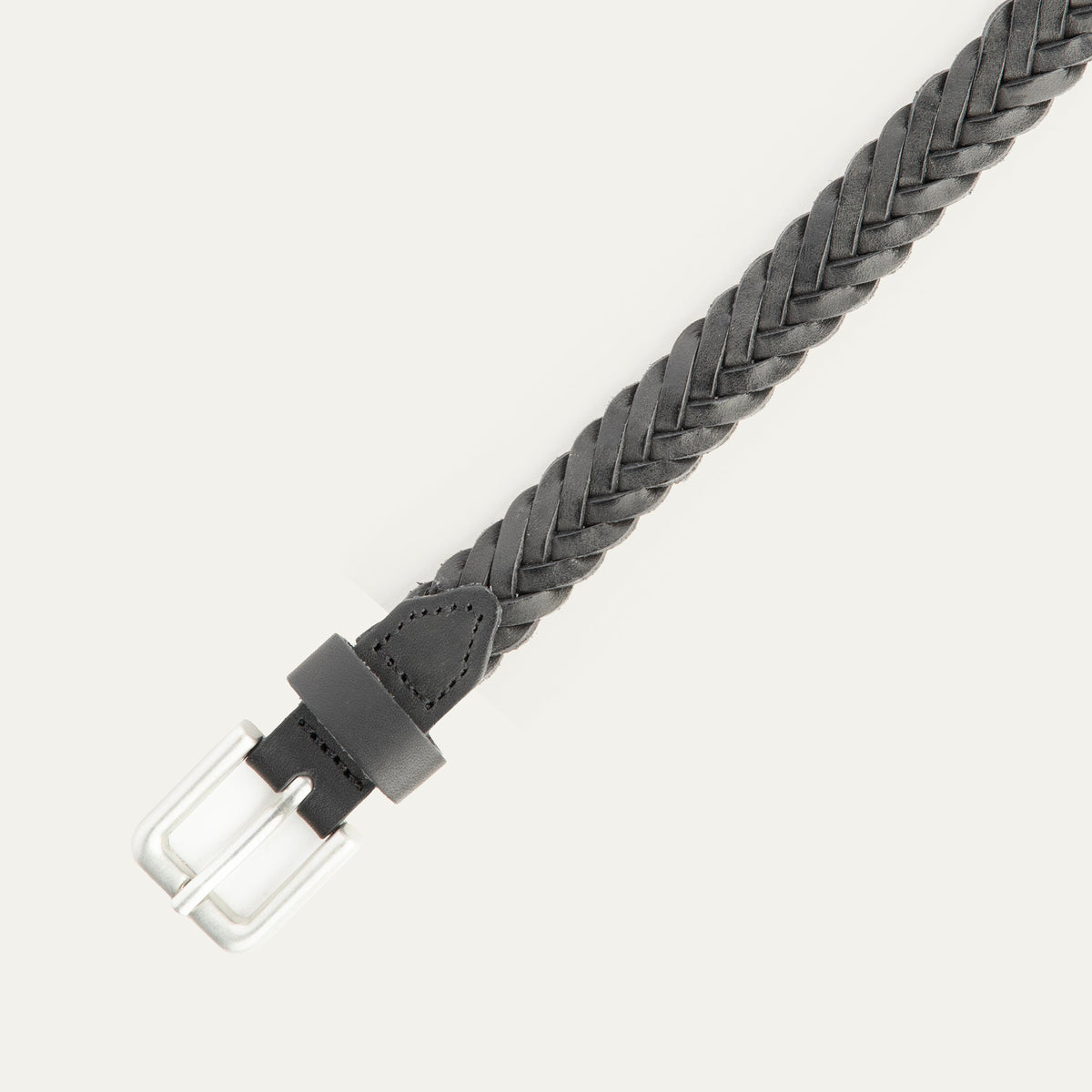 Close-up of the black Five Strand Braided Belt's brushed silver buckle and keeper loop, showing the five-strand leather braid detail.