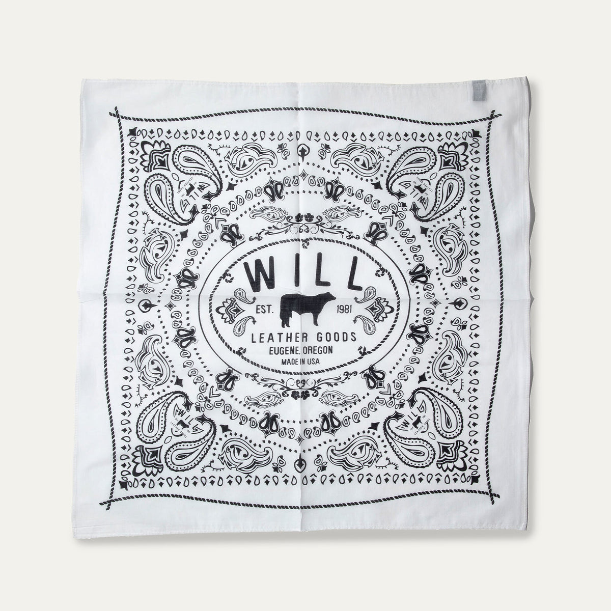 Will's Bandana in white with black paisley print, laid flat showing the center WILL Leather Goods cattle-brand logo, on a white background.