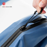A hand drawing the hexagonal zipper tab along the airtight zipper of a Steel Blue TILLIV Compak pack