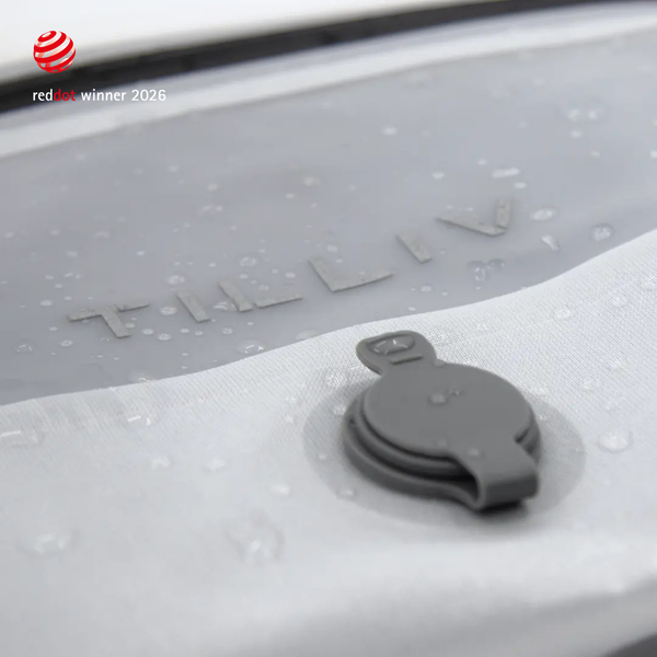 Water beading on the surface of a white TILLIV Compak pack beside its one-way valve, showing the water-resistant coating