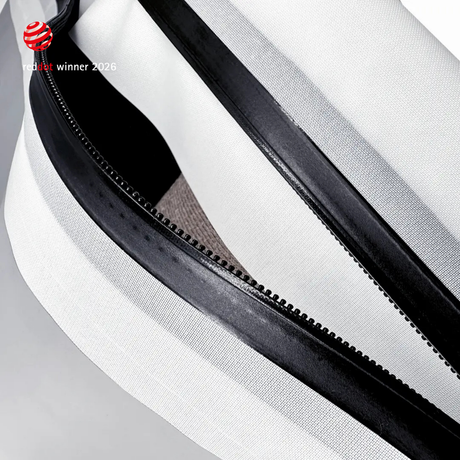 Extreme close-up of the black airtight zipper running along a white TILLIV Compak pack