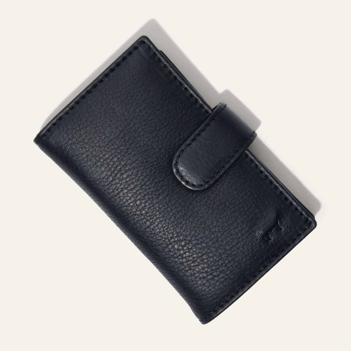 Will Leather Goods Signature Women's Cardholder Wallet in black leather, closed with snap tab, embossed cattle-brand logo on the front, on a white background.