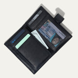 Black leather cardholder wallet open, showing card slots, a clear ID window, and a cash pocket holding a bill, on a white background.