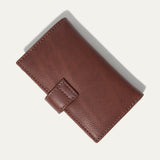 Will Leather Goods Signature Women's Cardholder Wallet in cognac leather, closed, angled front view with the snap-tab closure, on a white background.