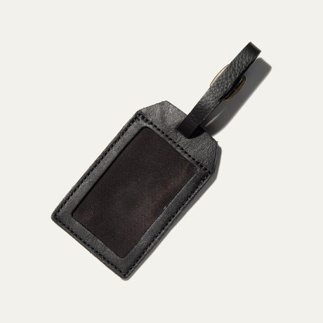 Back of the black leather luggage tag, showing the clear ID window insert for a name and address card