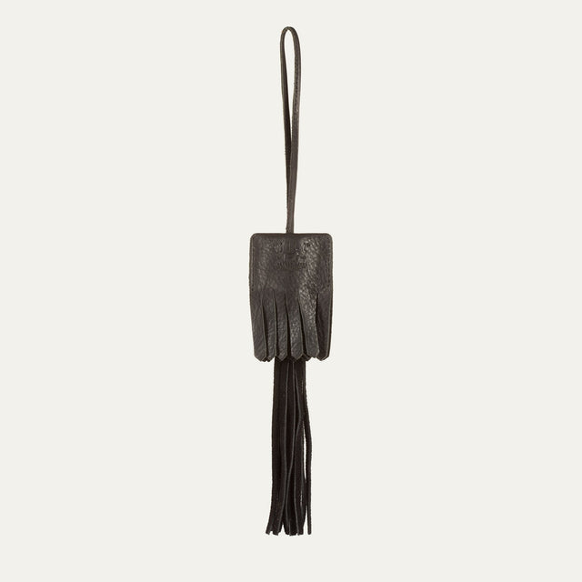 WILL Leather Goods key fob tassel in black leather, fringed tassel with embossed WILL Leather Goods patch and brass loop, on a white background.