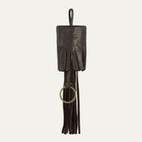 WILL Leather Goods key fob tassel in black leather, straight-on view showing the long fringe strands and embossed leather patch, on a white background.