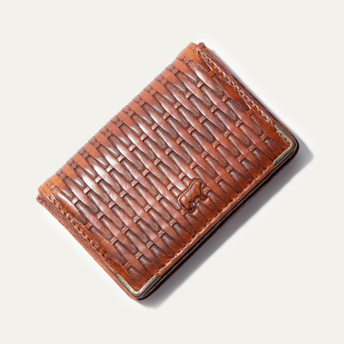 Will Leather Goods cognac basketweave-texture leather business card holder, corner angle view with brass corner guard