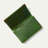 Green leather card holder open flat, showing the two empty card pockets