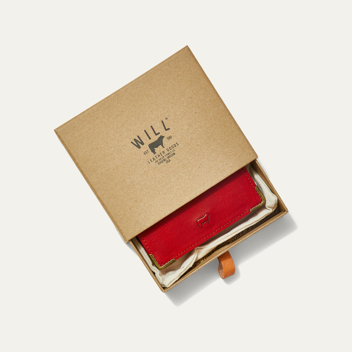 Red leather card holder in a Will Leather Goods kraft gift box with canvas lining