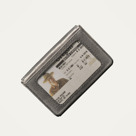 Close-up of the black leather card holder's clear ID window showing a driver's license