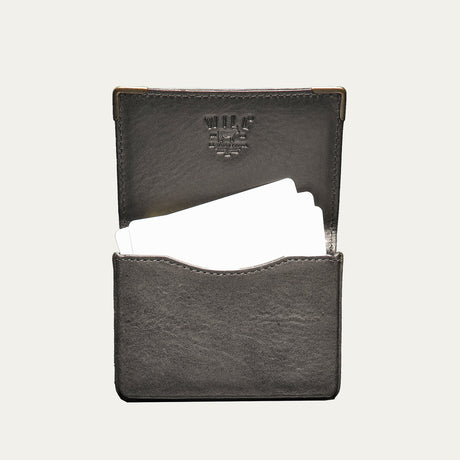 Black leather card holder open flat, showing business cards tucked into the pocket