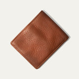 Will Leather Goods Classic Billfold Wallet in tan leather, closed, angled view showing the smooth leather texture and embossed cow logo.