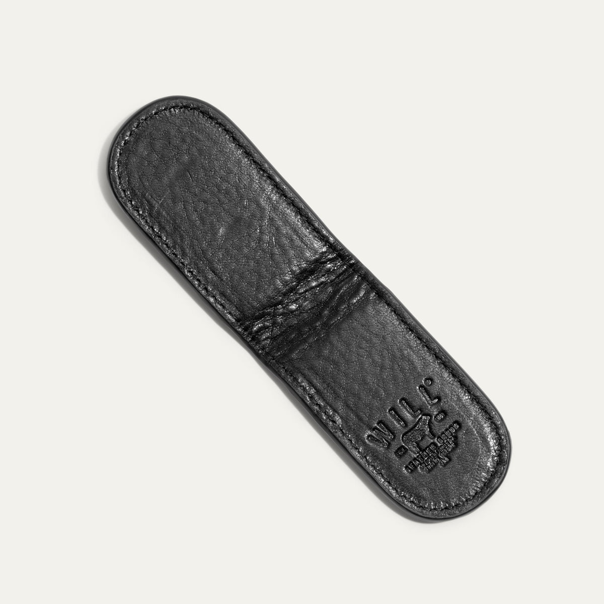 Underside view of the black Classic Money Clip showing the smooth leather sole and embossed WILL Leather Goods, Eugene Oregon stamp.
