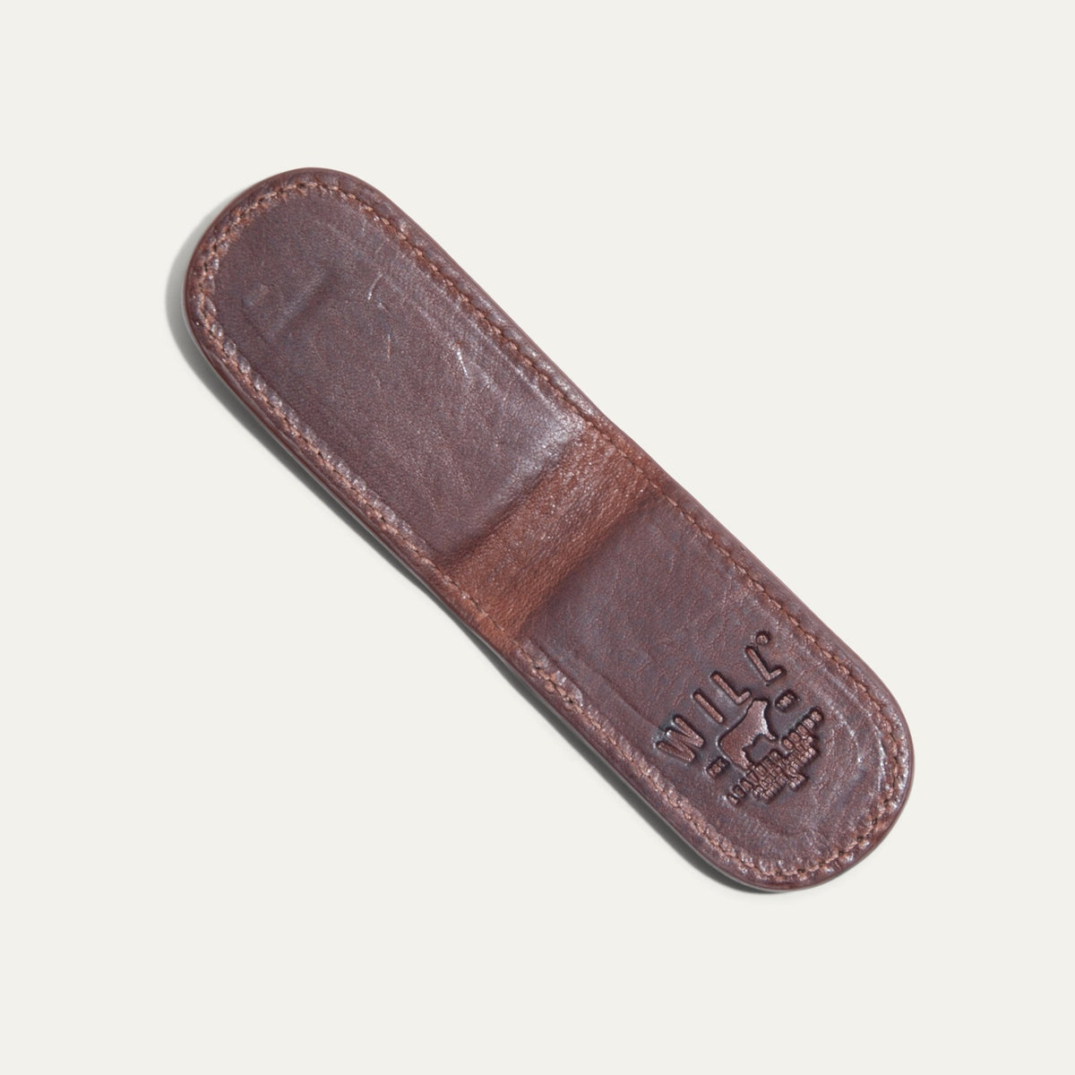 Underside view of the cognac Classic Money Clip showing the smooth leather sole and embossed WILL Leather Goods, Eugene Oregon stamp.