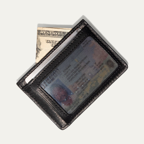 Black leather card case with a bill tucked beside a card visible through the clear ID window, on a white background.