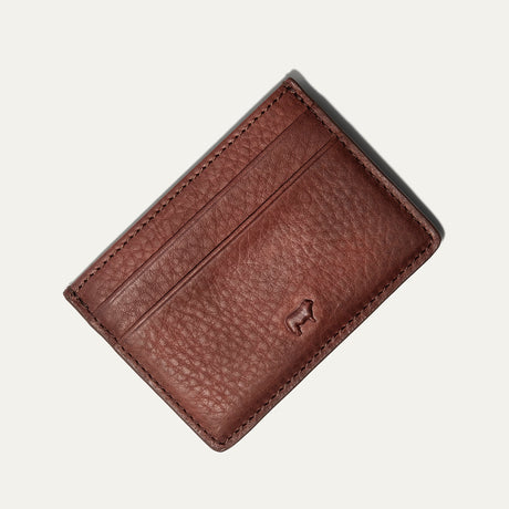 Will Leather Goods Classic Front Pocket Card Case in cognac leather, flat lay showing the plain back with embossed cattle-brand logo, on a white background.