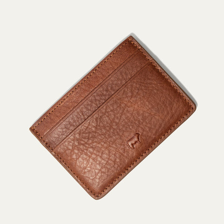 Will Leather Goods Classic Front Pocket Card Case in tan leather, flat lay showing the plain back with embossed cattle-brand logo, on a white background.