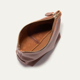 Cognac leather zip pouch open at the top, showing the empty tan suede-lined interior
