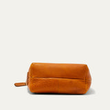 Bottom view of the tan leather zip pouch, showing the boxed base seams