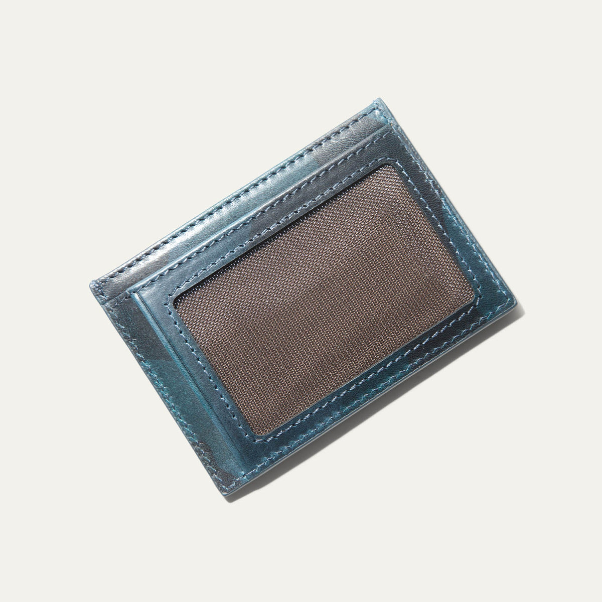 Close-up of the blue camo leather card case's back panel showing card slots and embossed cattle logo