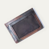 Brown camo leather card case tucked partway into a Will Leather Goods canvas drawstring pouch