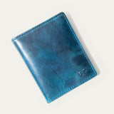 Closed view of the Military Front Pocket wallet in blue camouflage leather with embossed WILL cattle logo, on a white background.