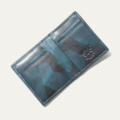 Overhead view of the blue camouflage Military Front Pocket wallet open flat, showing the card slots and embossed WILL cattle logo.