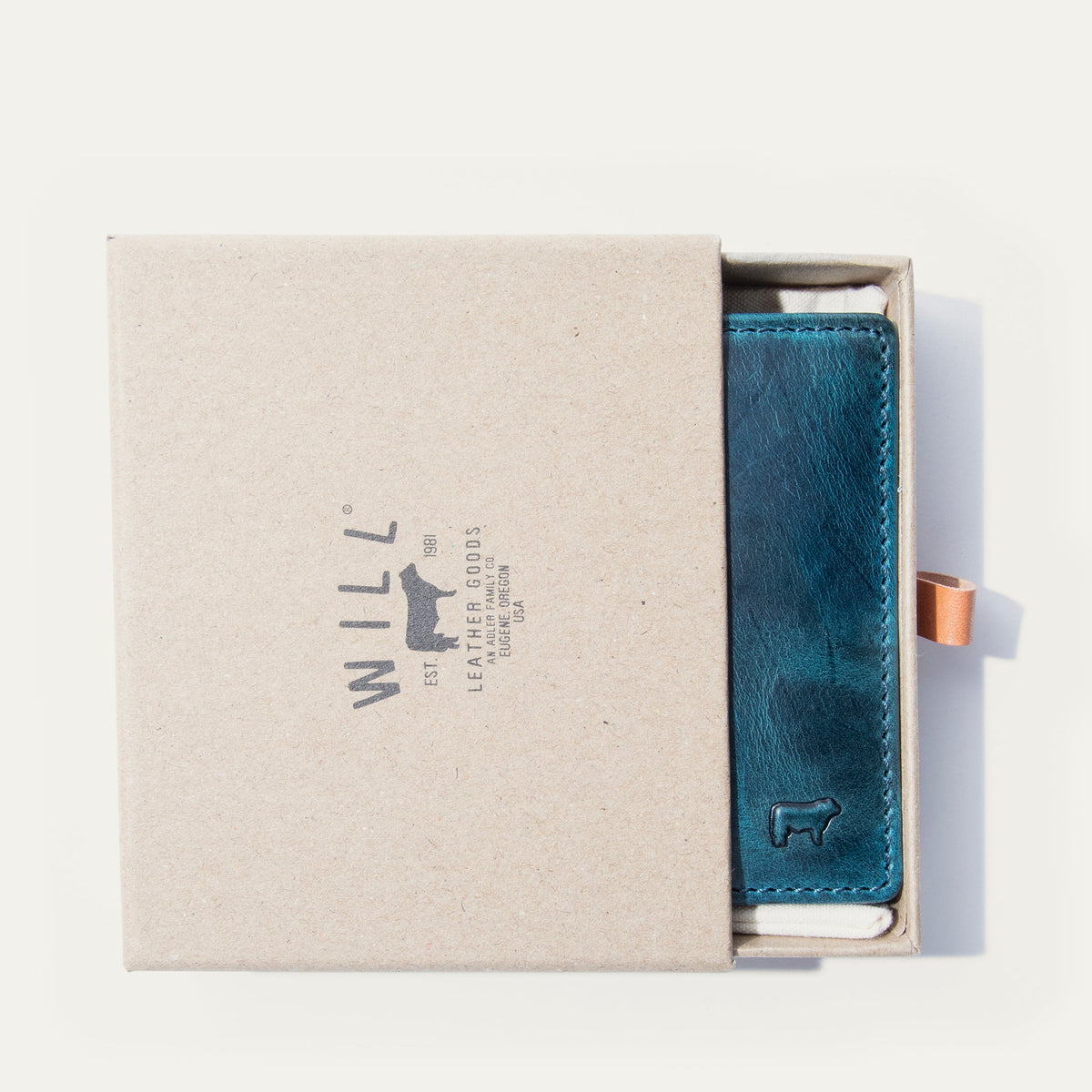 The blue camouflage Military Front Pocket wallet in its WILL Leather Goods gift box, nested in white tissue with a leather pull-tab.