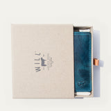 The blue camouflage Military Front Pocket wallet in its WILL Leather Goods gift box, nested in white tissue with a leather pull-tab.