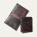 Military Front Pocket wallet in green camouflage leather, shown open (trifold interior with card slots and embossed WILL logo) and closed, on a white background.