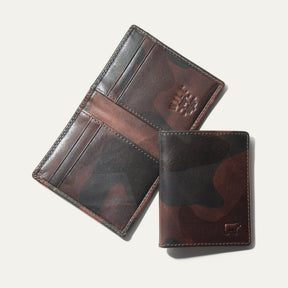 Military Front Pocket wallet in green camouflage leather, shown open (trifold interior with card slots and embossed WILL logo) and closed, on a white background.