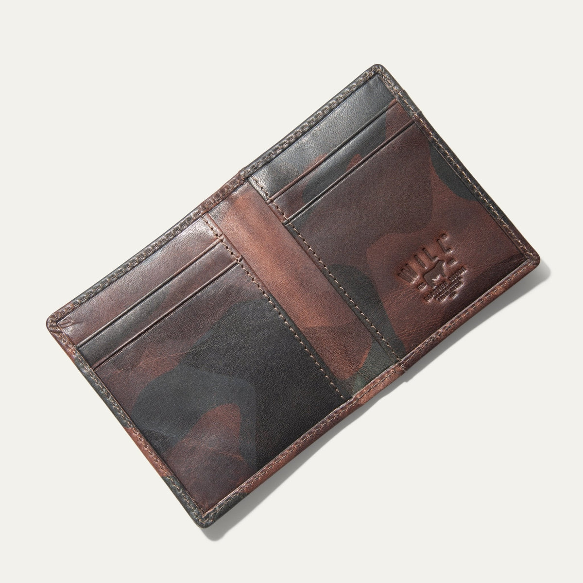 Overhead view of the green camouflage Military Front Pocket wallet open flat, showing the card slots and embossed WILL cattle logo.
