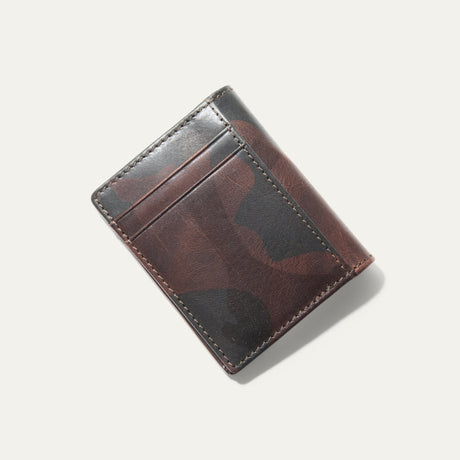 Angled close-up of the green camouflage leather on the closed Military Front Pocket wallet, showing the mottled camo pattern and stitching.
