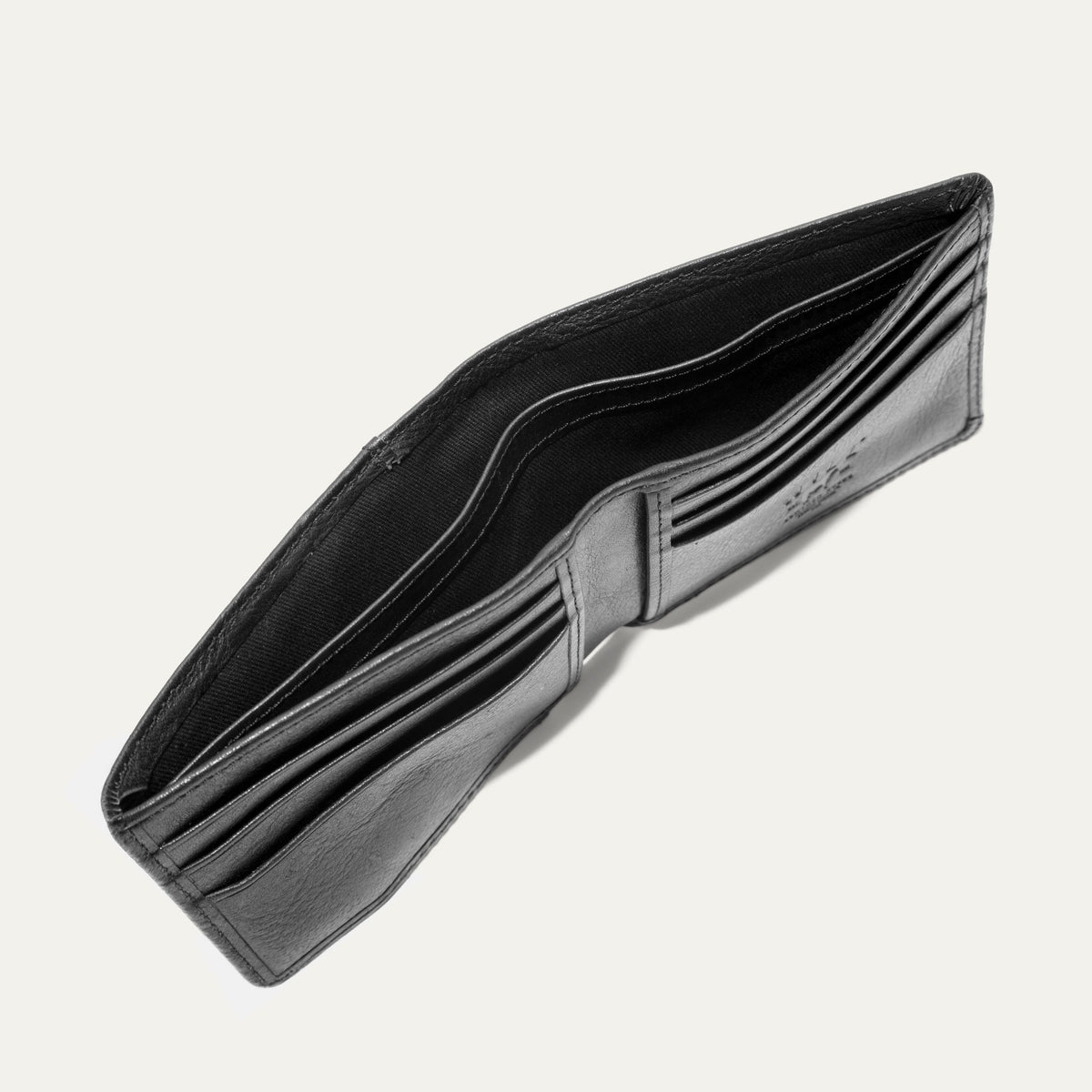 Companion Billfold Wallet by WILL Leather Goods in black leather, interior view of the empty unfolded bifold showing the card slots and bill compartment.