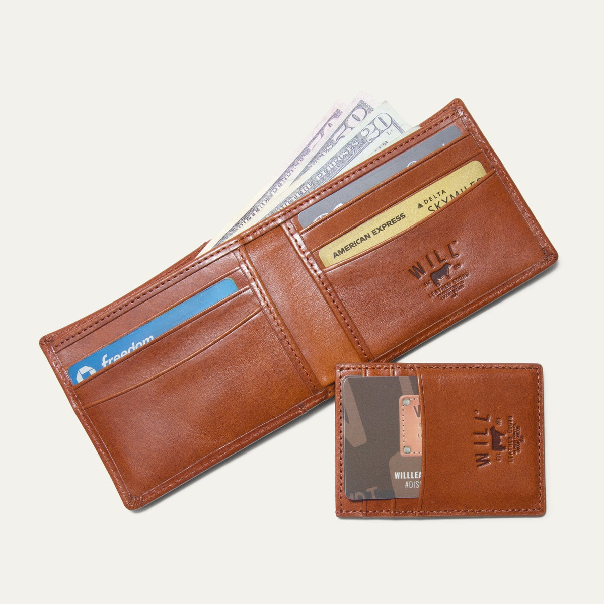 Companion Billfold Wallet by WILL Leather Goods in cognac leather, open with cash and cards fanned out, paired with the detachable front-pocket card case holding a driver's license and discount card.
