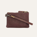 Cognac leather zip pouch, three-quarter view with wristlet strap draped across the front