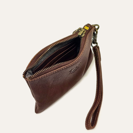 Cognac leather zip pouch open at an angle, showing interior card slots and wristlet strap