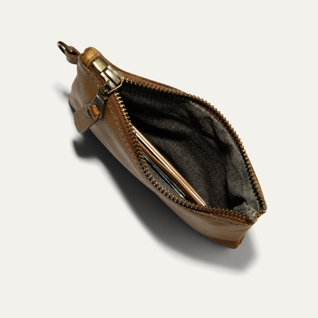 Tan leather zip pouch open at an angle, showing interior card slots and wristlet strap