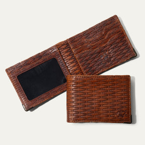 The William Collection Mogul Billfold in cognac basketweave-embossed leather, shown open (trifold with mesh ID window) and closed (bifold), on a white background.