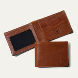 Close-up of the cognac basketweave leather texture on the closed Mogul Billfold with embossed WILL cattle logo in the corner.