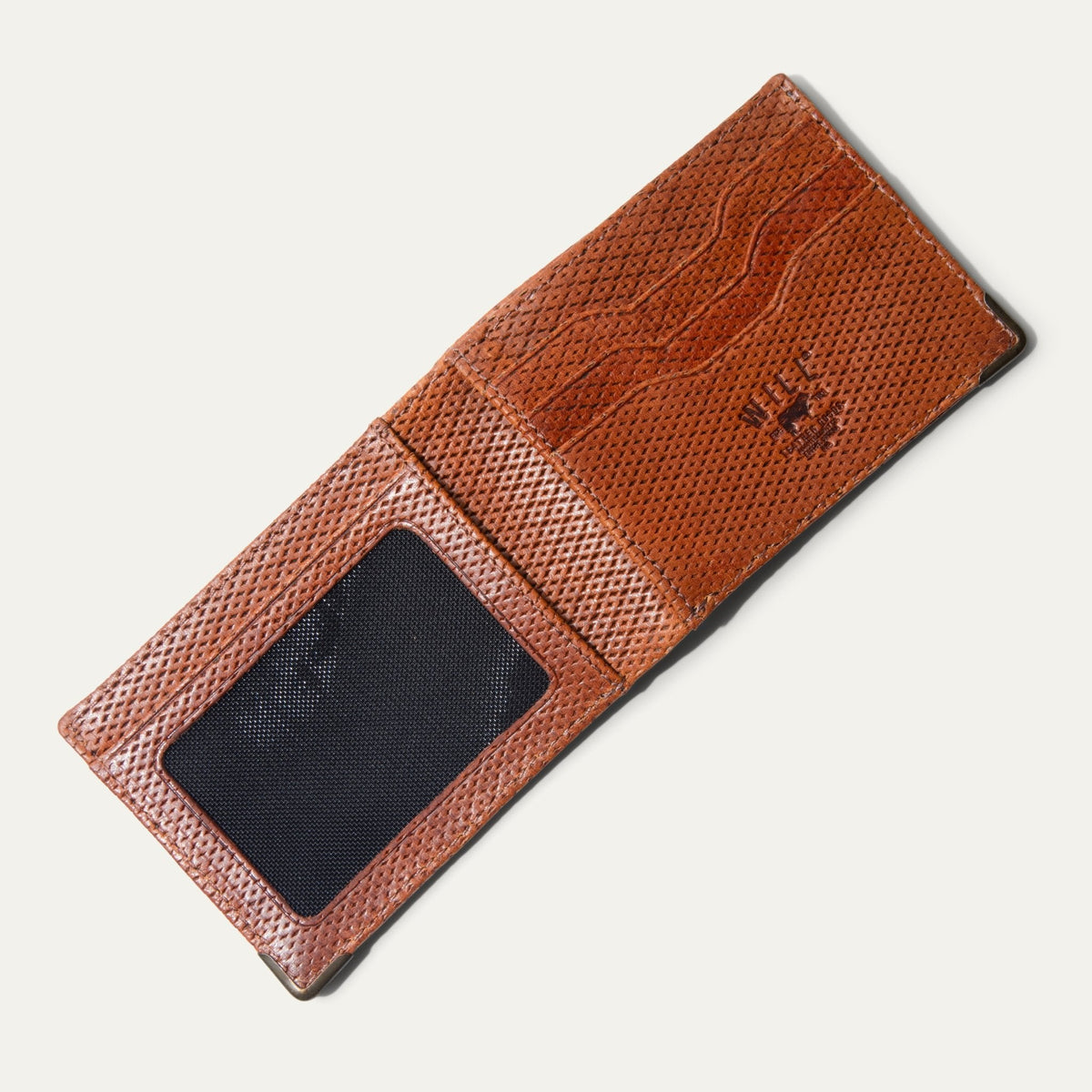 Closed view of the Mogul Billfold in ginger diamond-perforated leather with embossed WILL cattle logo, on a white background.