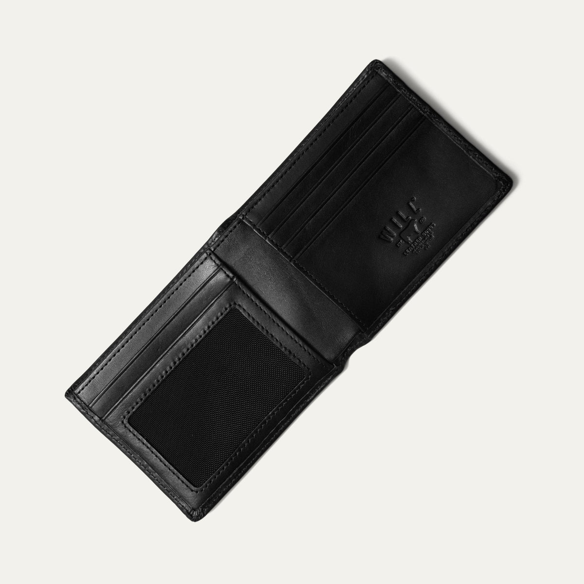 Black leather billfold wallet closed, angled front view showing the embossed cattle-brand logo, on a white background.