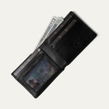 Black leather billfold wallet open, card pocket holding cash and an ID visible through the clear window, on a white background.