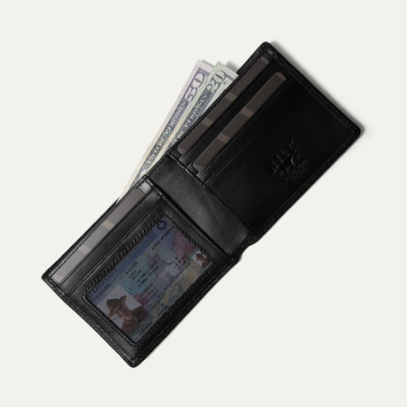 Black leather billfold wallet open, card pocket holding cash and an ID visible through the clear window, on a white background.